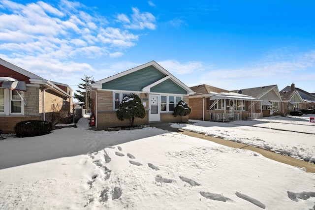 view of front of house featuring a residential view, fence, and brick siding