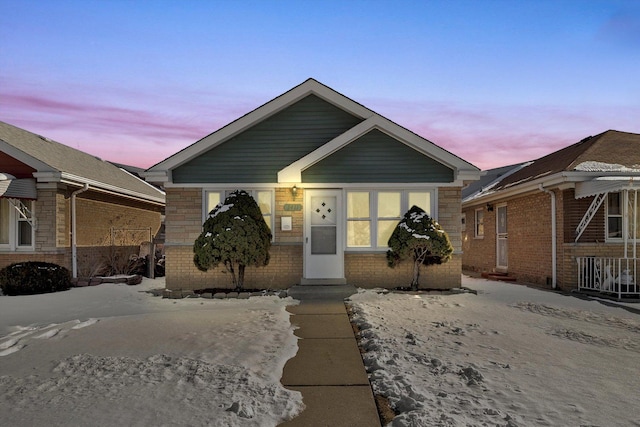 bungalow-style home featuring brick siding