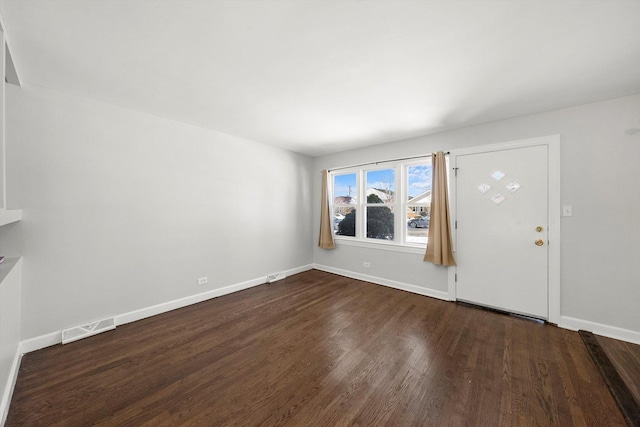 entrance foyer featuring baseboards, visible vents, and dark wood finished floors