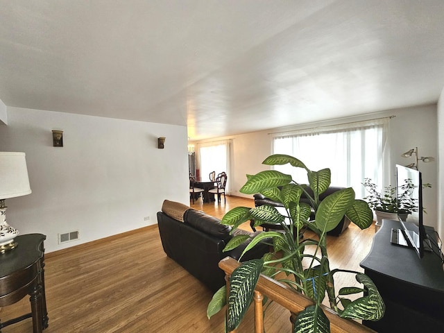 living room with visible vents and wood finished floors