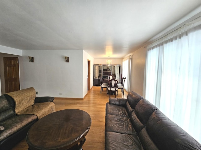 living area featuring a chandelier and wood finished floors