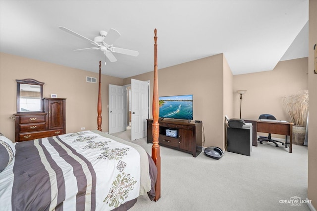 bedroom featuring a ceiling fan, visible vents, and light carpet