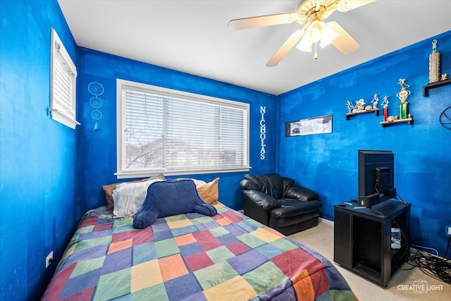 bedroom featuring ceiling fan and carpet