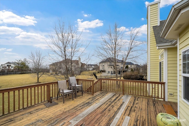 deck with a residential view and a lawn