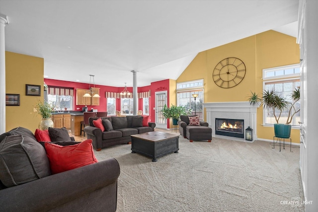 living area featuring vaulted ceiling, a fireplace with flush hearth, carpet, and baseboards