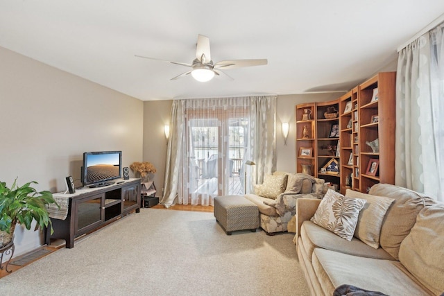 carpeted living room with ceiling fan