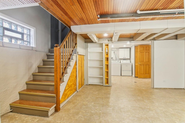 below grade area featuring tile patterned floors, wood ceiling, stairway, and independent washer and dryer