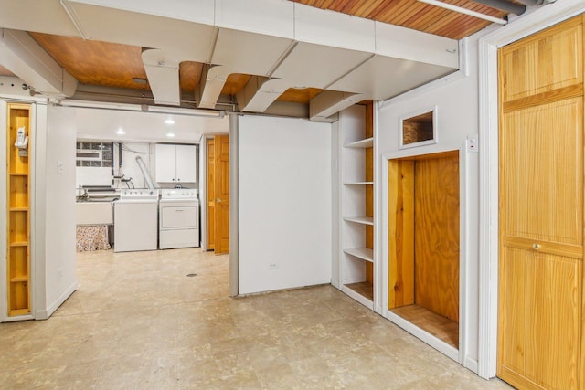 finished basement with light floors and washer and dryer