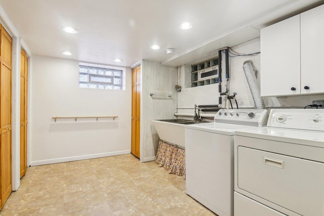 clothes washing area with recessed lighting, a sink, baseboards, cabinet space, and washer and clothes dryer