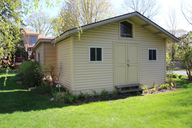 view of outdoor structure with an outbuilding and fence