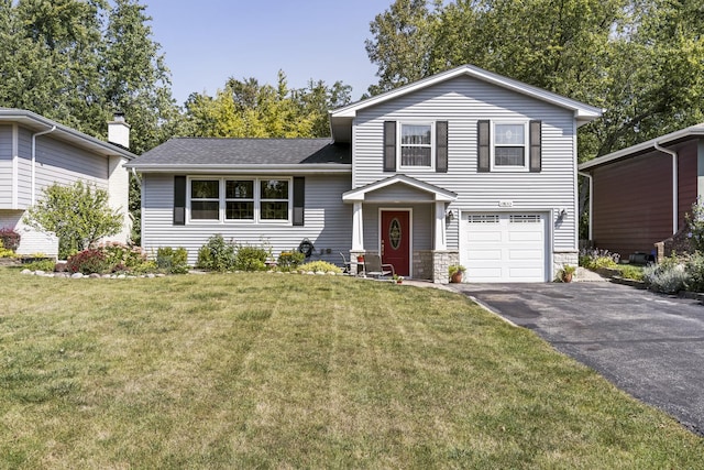 split level home featuring a garage, driveway, stone siding, roof with shingles, and a front lawn