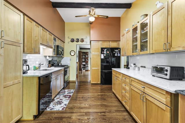 kitchen with dark wood-type flooring, a sink, backsplash, black appliances, and glass insert cabinets