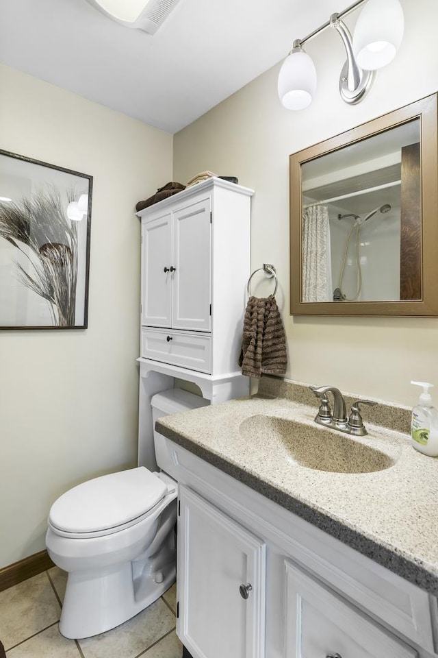 bathroom featuring toilet, a shower with curtain, vanity, and tile patterned floors