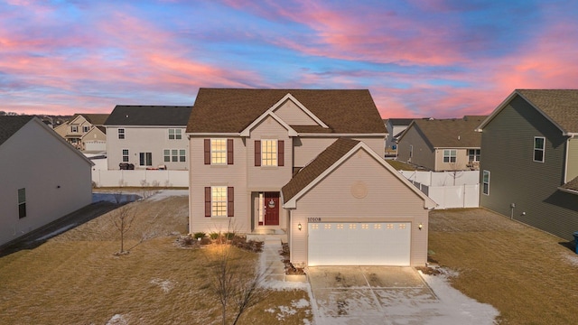 view of front of home featuring a yard and a garage