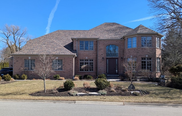 view of front of property with a front yard and brick siding