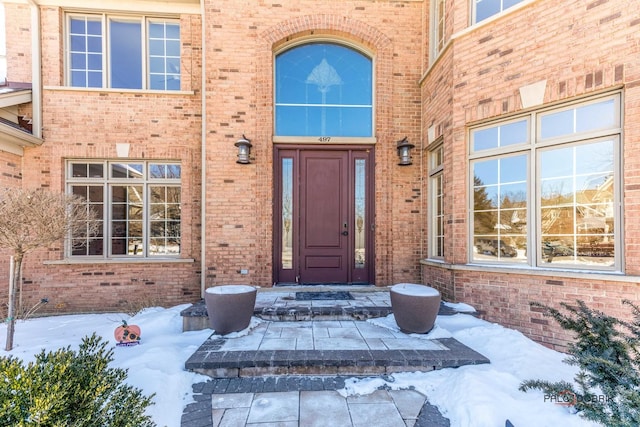 view of snow covered property entrance