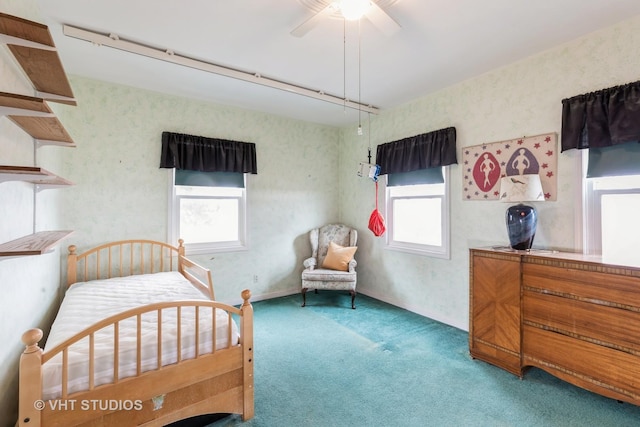 bedroom with carpet floors, a ceiling fan, and wallpapered walls