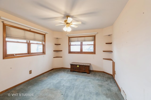 carpeted spare room with a ceiling fan, visible vents, and baseboards