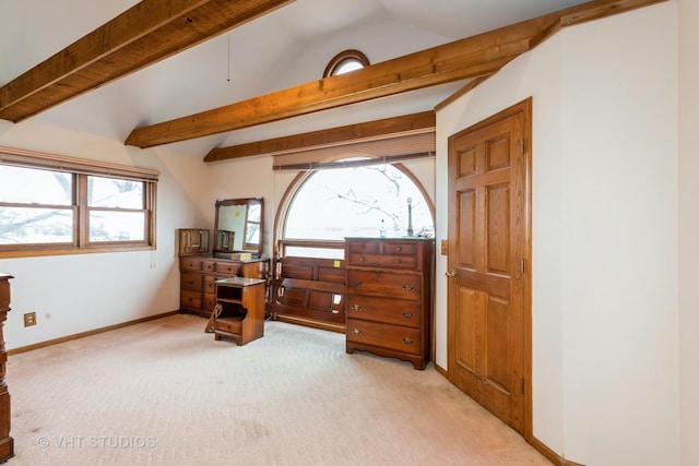 bedroom with lofted ceiling with beams, baseboards, and light colored carpet