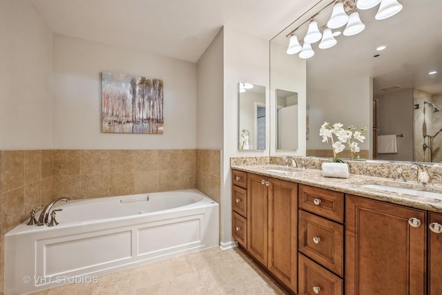 full bathroom featuring a garden tub, a sink, a shower stall, and double vanity