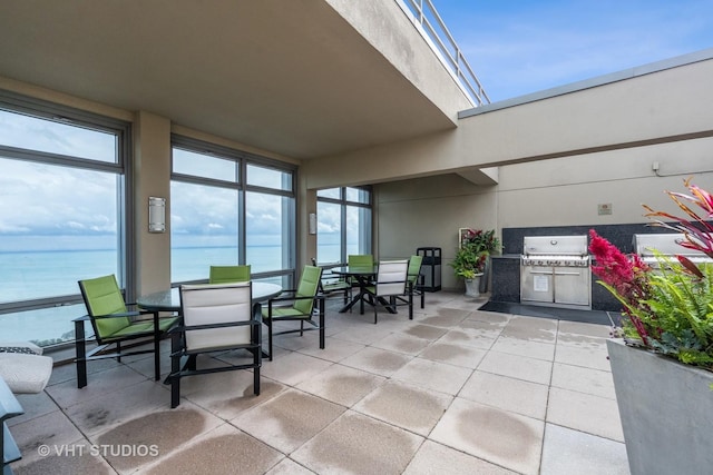 view of patio / terrace with outdoor dining area, a water view, grilling area, and area for grilling