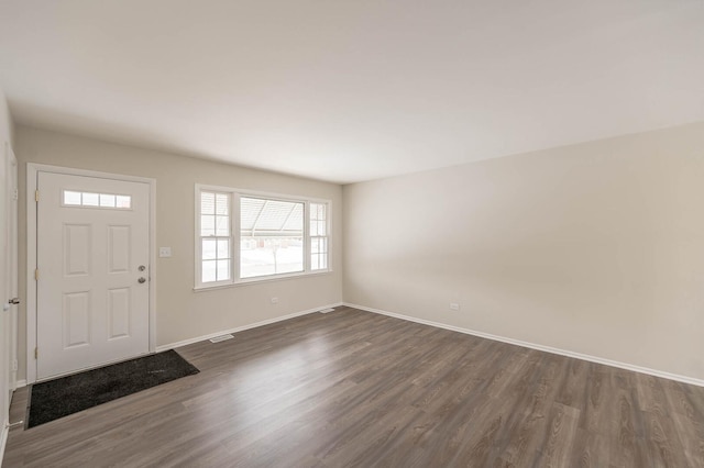 entryway featuring dark wood-style floors, visible vents, and baseboards