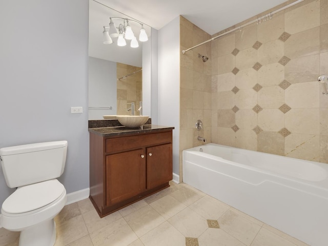 bathroom featuring tile patterned flooring, toilet, bathtub / shower combination, vanity, and baseboards