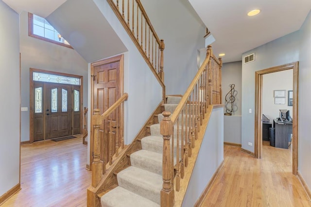 foyer entrance featuring light wood-type flooring, visible vents, and a wealth of natural light