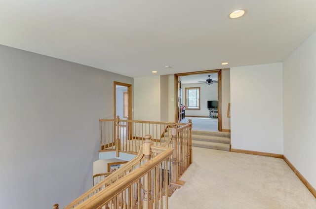 hallway featuring recessed lighting, carpet flooring, an upstairs landing, and baseboards