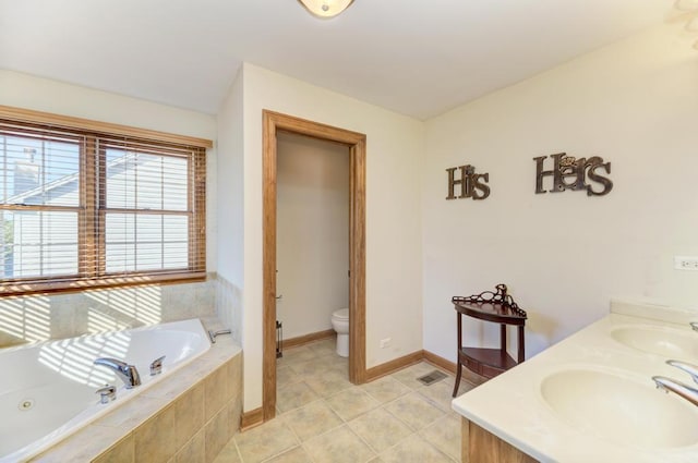 full bathroom with a garden tub, a sink, toilet, and tile patterned floors