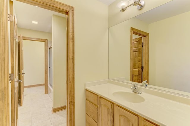 bathroom featuring shower / bath combination with glass door, tile patterned flooring, and vanity