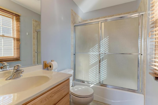 bathroom featuring shower / bath combination with glass door, vanity, and toilet