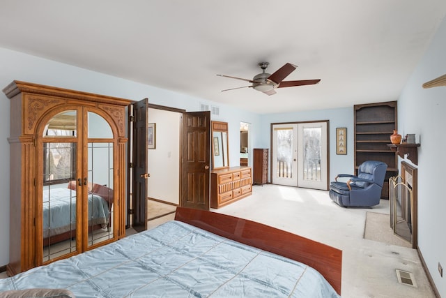 bedroom with access to exterior, visible vents, french doors, and light carpet