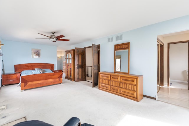 bedroom featuring visible vents, baseboards, carpet, and a ceiling fan