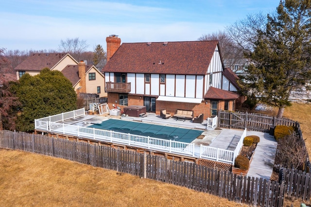 view of pool featuring a patio area, an outdoor hangout area, a fenced backyard, and a hot tub