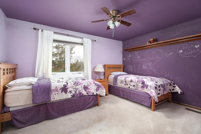 carpeted bedroom featuring visible vents and a ceiling fan