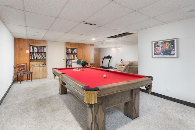 playroom with wooden walls, visible vents, baseboards, a drop ceiling, and carpet floors