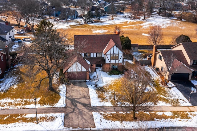 snowy aerial view with a residential view