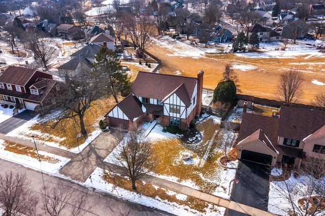 snowy aerial view featuring a residential view