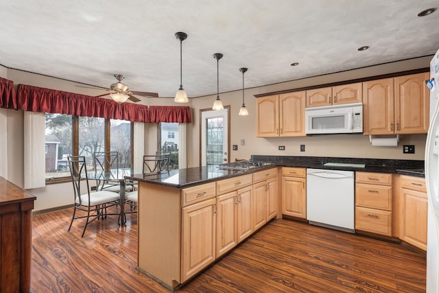 kitchen with white appliances, a peninsula, dark wood-style floors, and light brown cabinetry