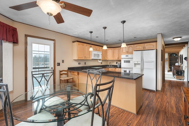 kitchen featuring dark wood finished floors, white appliances, a peninsula, and light brown cabinetry