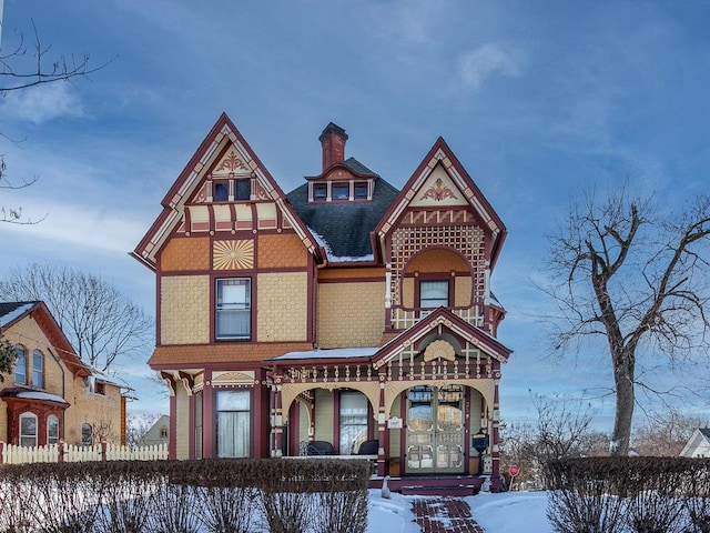 victorian-style house featuring covered porch and french doors