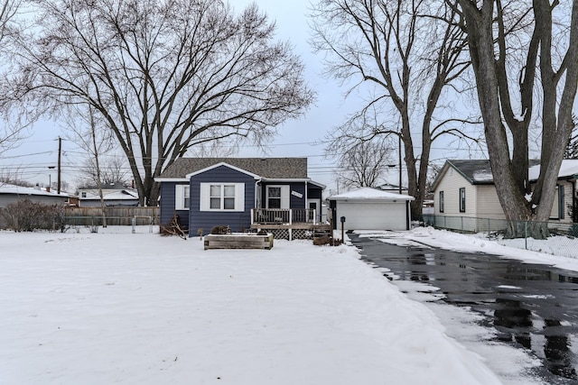 view of front of house with a garage, an outbuilding, and a deck