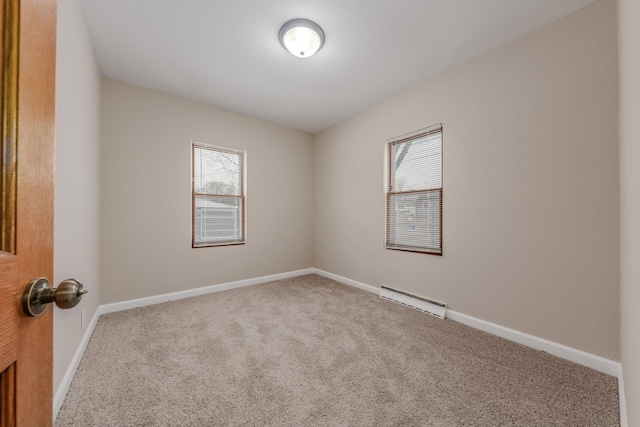 unfurnished room featuring carpet flooring and baseboard heating