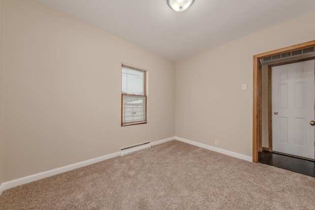 spare room with carpet and baseboard heating