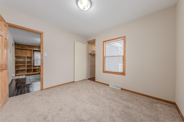 unfurnished bedroom featuring carpet floors and a closet