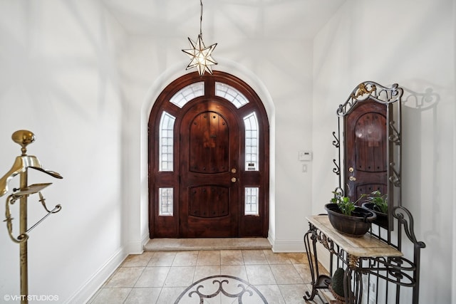 foyer featuring light tile patterned floors and baseboards