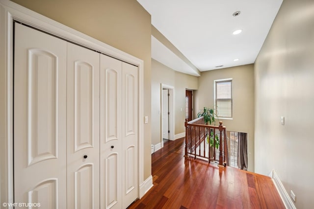 corridor featuring recessed lighting, baseboards, dark wood finished floors, and an upstairs landing