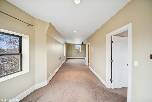 hall featuring light carpet, recessed lighting, and baseboards