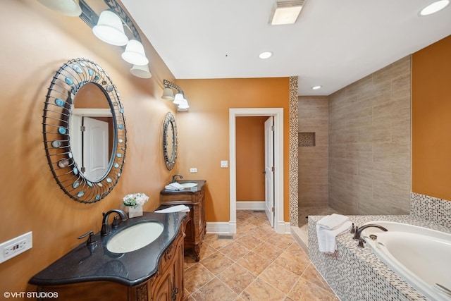 bathroom with a walk in shower, a garden tub, two vanities, a sink, and baseboards